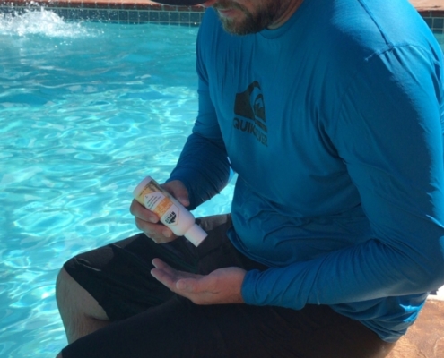 man in a swimming pool uses fragrance free sunscreen