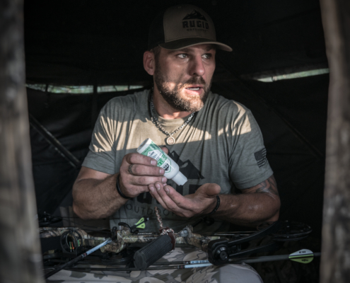 man using rugid bug repellent lotion